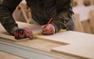 professional-carpenter-in-ajman-measuring-wooden-panels-for-custom-furniture
