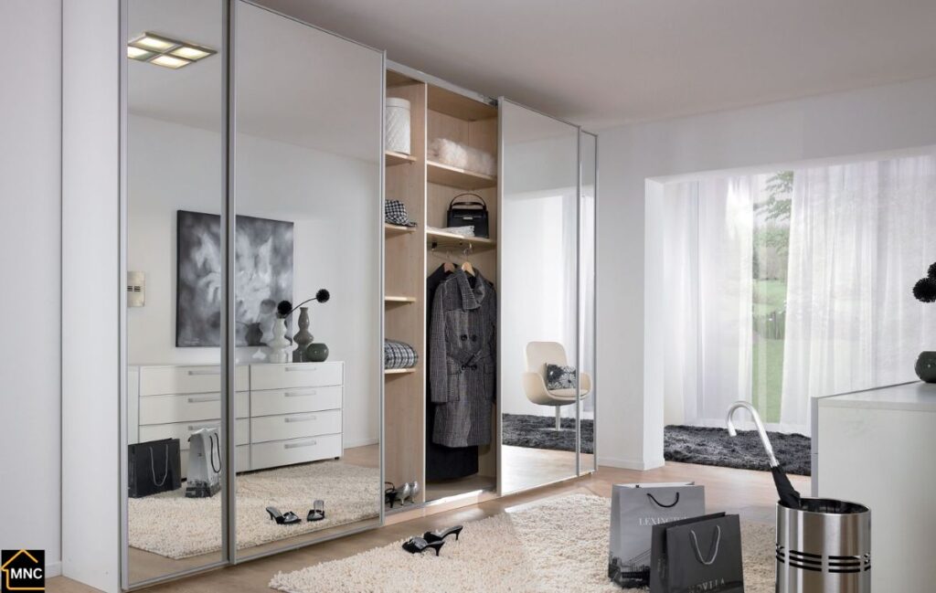 Sliding mirrored wardrobe designed by MNC Carpentry in Dubai Marina apartment